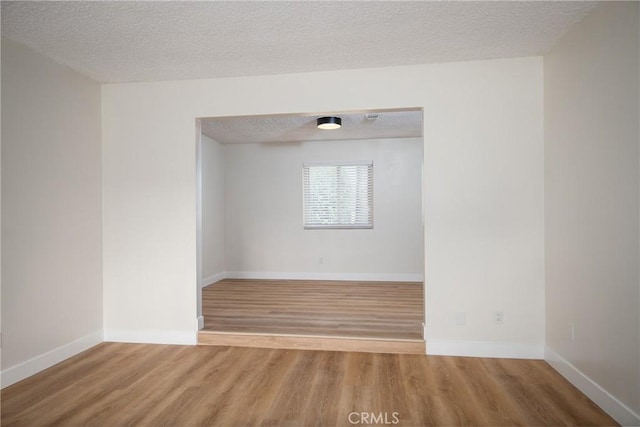 25070 Tulip Ave, Loma Linda, CA 92354 - spare room with wood finished floors and a textured ceiling