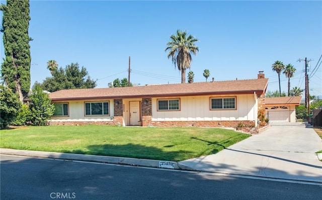 25070 Tulip Ave, Loma Linda, CA 92354 - ranch-style home with a chimney, a front yard, concrete driveway, and board and batten siding
