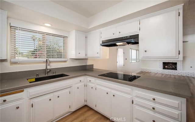 25070 Tulip Ave, Loma Linda, CA 92354 - kitchen featuring under cabinet range hood, black electric cooktop, plenty of natural light, and white cabinetry