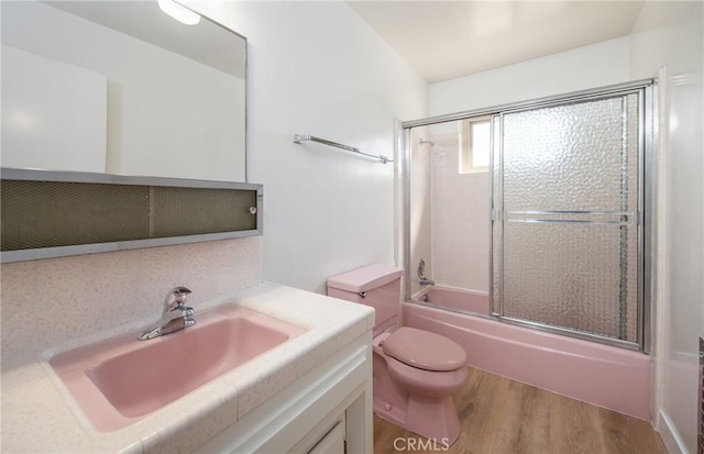 25070 Tulip Ave, Loma Linda, CA 92354 - full bath featuring vanity, wood finished floors, and bath / shower combo with glass door