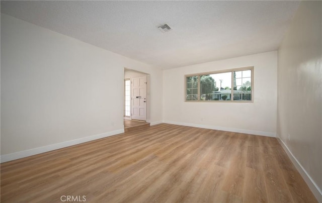 25070 Tulip Ave, Loma Linda, CA 92354 - spare room featuring light wood finished floors and a textured ceiling