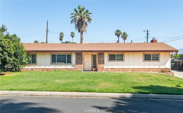 25070 Tulip Ave, Loma Linda, CA 92354 - single story home with board and batten siding, a front lawn, and a chimney