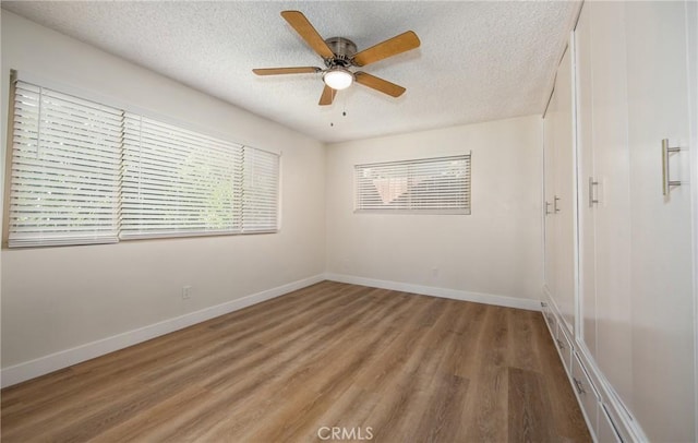 25070 Tulip Ave, Loma Linda, CA 92354 - spare room featuring a textured ceiling, light wood-style flooring, and a ceiling fan