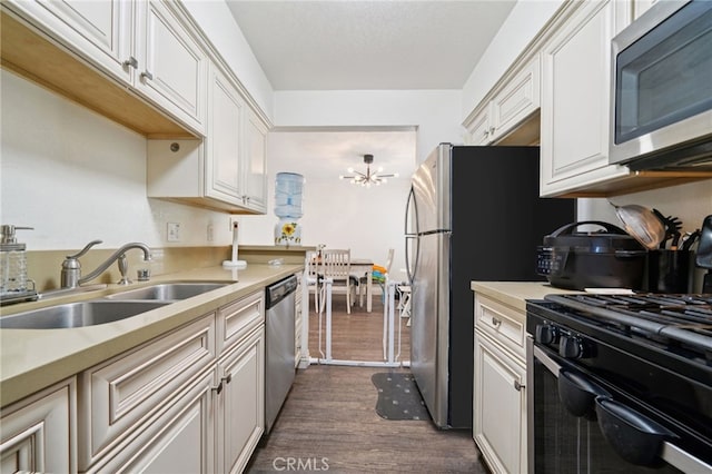 1748 S Mountain Ave Unit A, Ontario, CA 91762 - kitchen featuring appliances with stainless steel finishes, dark wood-type flooring, light countertops, and white cabinetry