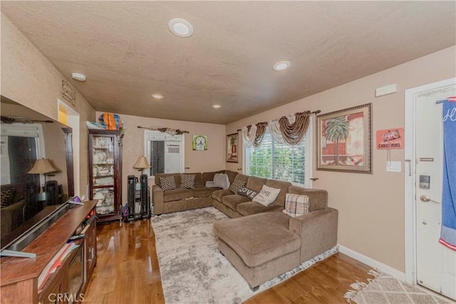 1493 W Grand Ave, Pomona, CA 91766 - living area with wood finished floors, recessed lighting, and a textured ceiling