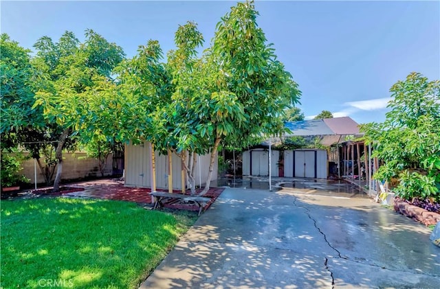 1493 W Grand Ave, Pomona, CA 91766 - view of front of house with a storage shed, a patio area, and a fenced backyard