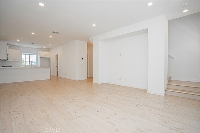 1239 Bonnet Way, Torrance, CA 90502 - unfurnished living room with light wood-style floors, recessed lighting, and stairs