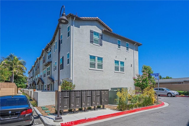 1239 Bonnet Way, Torrance, CA 90502 - view of side of property featuring mail area, stucco siding, and uncovered parking