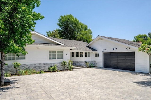 17437 Chase St, Northridge, CA 91325 - single story home featuring an attached garage, decorative driveway, stone siding, and a shingled roof