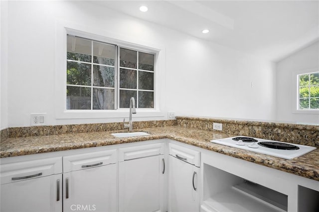 17437 Chase St, Northridge, CA 91325 - kitchen with white electric stovetop, white cabinets, stone counters, recessed lighting, and lofted ceiling
