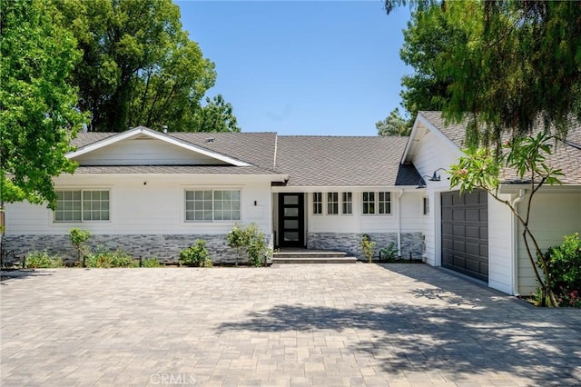 17437 Chase St, Northridge, CA 91325 - single story home with an attached garage, roof with shingles, decorative driveway, and stone siding