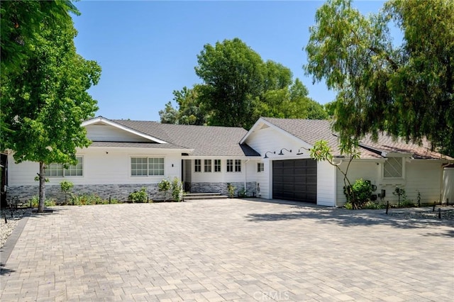 17437 Chase St, Northridge, CA 91325 - ranch-style home with an attached garage, decorative driveway, and stone siding