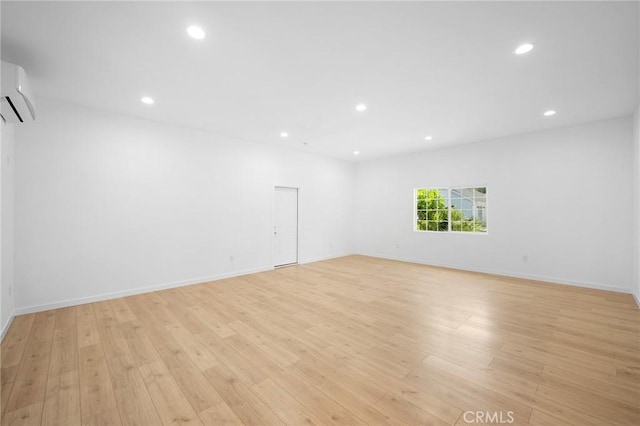 17437 Chase St, Northridge, CA 91325 - empty room featuring recessed lighting, light wood-type flooring, and an AC wall unit