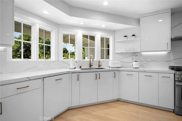 17437 Chase St, Northridge, CA 91325 - kitchen with open shelves, stainless steel gas range oven, backsplash, white cabinetry, and recessed lighting