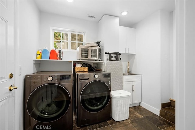 17437 Chase St, Northridge, CA 91325 - laundry area with washer and clothes dryer, cabinet space, dark stone finish flooring, and recessed lighting