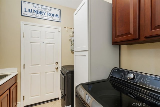 31676 Brentworth St, Menifee, CA 92584 - washroom featuring washer and clothes dryer, cabinet space, and light tile patterned floors