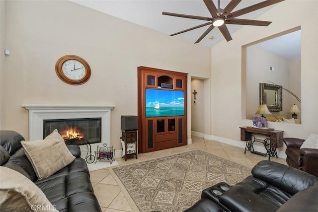31676 Brentworth St, Menifee, CA 92584 - tiled living room with ceiling fan, a glass covered fireplace, and high vaulted ceiling