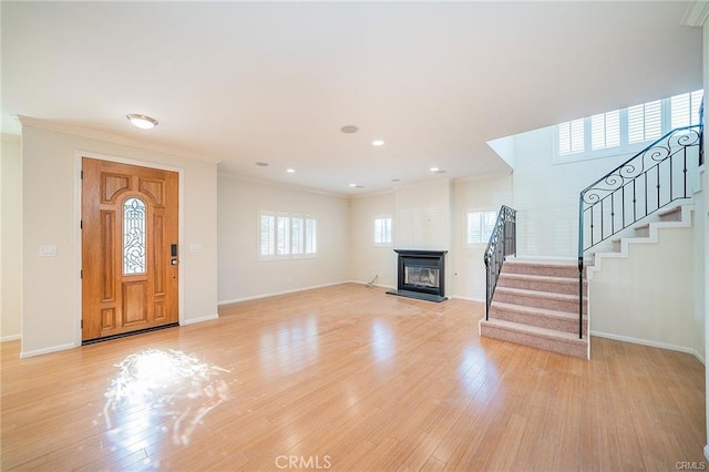 16714 Inglewood Ave Unit A, Lawndale, CA 90260 - foyer entrance with a glass covered fireplace, stairway, ornamental molding, light wood-style flooring, and recessed lighting