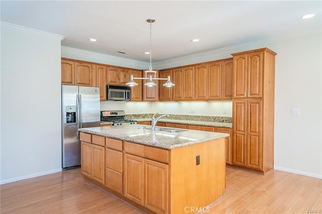 16714 Inglewood Ave Unit A, Lawndale, CA 90260 - kitchen featuring stainless steel appliances, light stone counters, a kitchen island with sink, light wood-type flooring, and recessed lighting