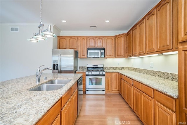 16714 Inglewood Ave Unit A, Lawndale, CA 90260 - kitchen featuring appliances with stainless steel finishes, light wood-style floors, light stone countertops, hanging light fixtures, and crown molding