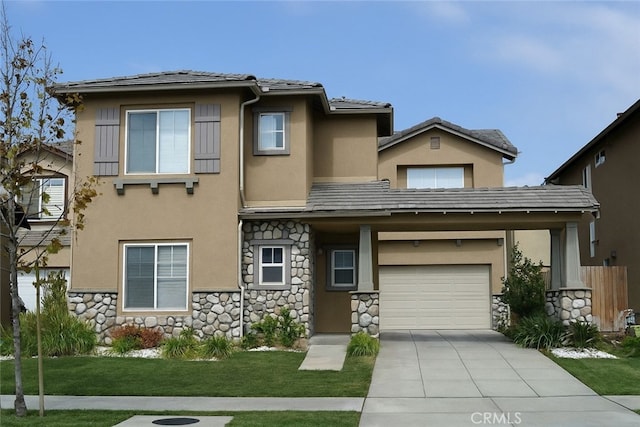 2237 Pajaro St, Oxnard, CA 93030 - view of front facade featuring stone siding, a garage, stucco siding, driveway, and a front lawn
