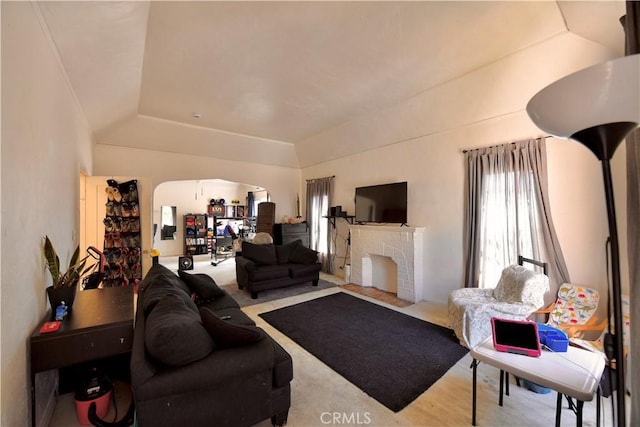 3945 Woolwine Dr, Los Angeles, CA 90063 - living area featuring lofted ceiling, arched walkways, a raised ceiling, and a brick fireplace