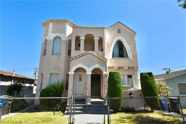 3945 Woolwine Dr, Los Angeles, CA 90063 - mediterranean / spanish home with a fenced front yard, stucco siding, and a gate