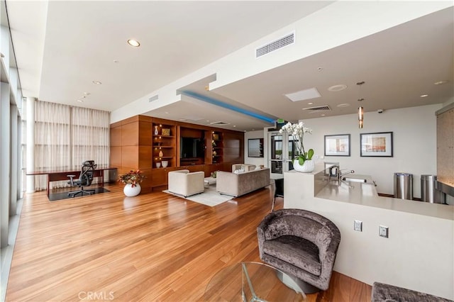 1155 S Grand Ave Unit 1008, Los Angeles, CA 90015 - living room featuring light wood-style floors and recessed lighting