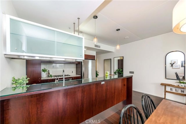 1155 S Grand Ave Unit 1008, Los Angeles, CA 90015 - kitchen featuring dark wood-style flooring, freestanding refrigerator, a peninsula, and decorative light fixtures