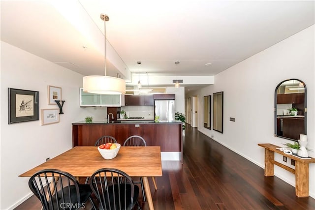 1155 S Grand Ave Unit 1008, Los Angeles, CA 90015 - dining space featuring dark wood-style flooring and baseboards