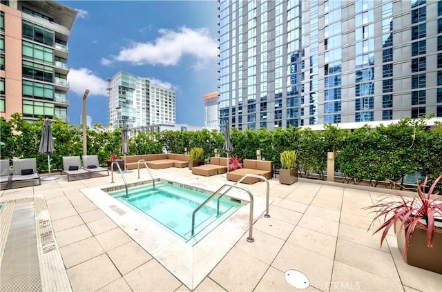 1155 S Grand Ave Unit 1008, Los Angeles, CA 90015 - view of swimming pool with a city view, a community hot tub, a patio, and outdoor lounge area