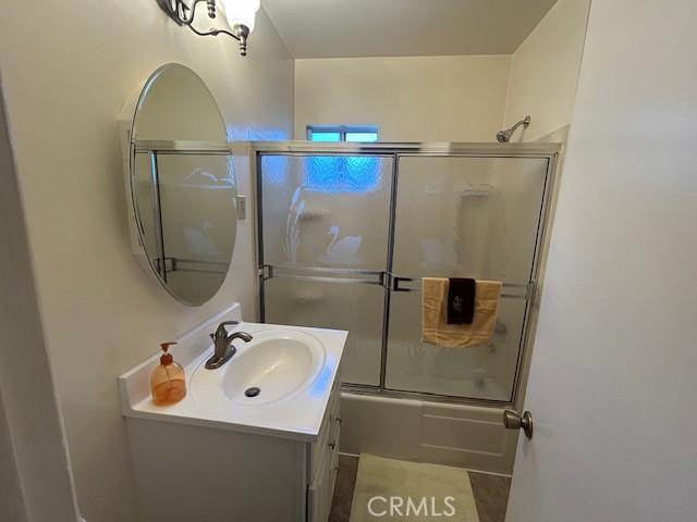 1220 W L St, Wilmington, CA 90744 - full bath featuring vanity and shower / bath combination with glass door