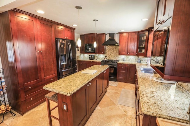 1560 Cavernt Pt, Chula Vista, CA 91911 - kitchen featuring stainless steel fridge with ice dispenser, wall chimney range hood, black gas range oven, reddish brown cabinets, and a kitchen island