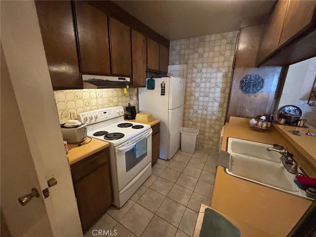 550 W Regent St Unit 338, Inglewood, CA 90301 - kitchen with white appliances, under cabinet range hood, light tile patterned flooring, light countertops, and decorative backsplash