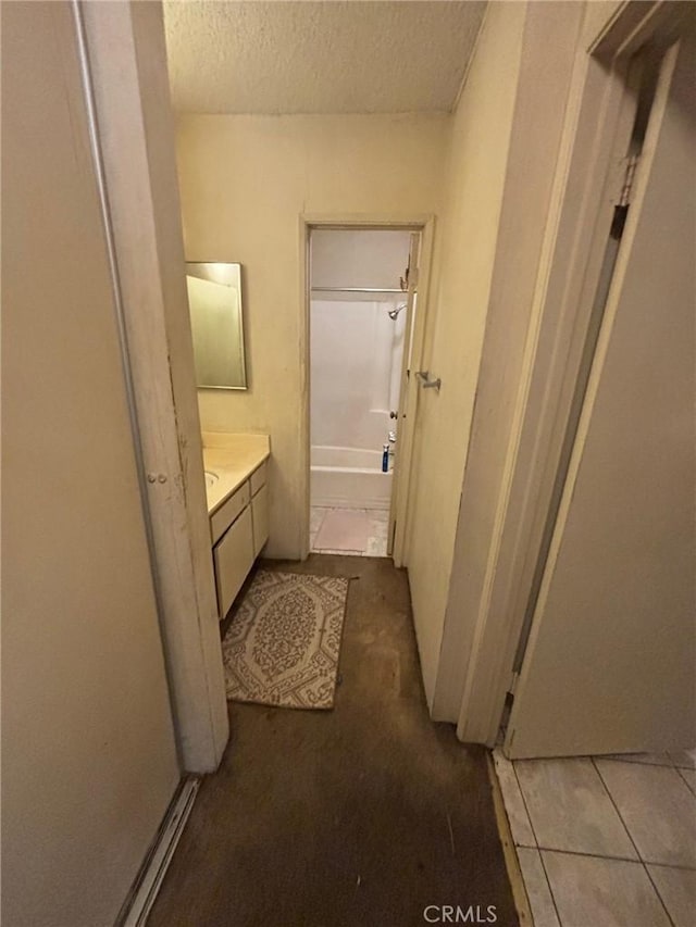 550 W Regent St Unit 338, Inglewood, CA 90301 - bathroom with vanity, a textured ceiling, and washtub / shower combination