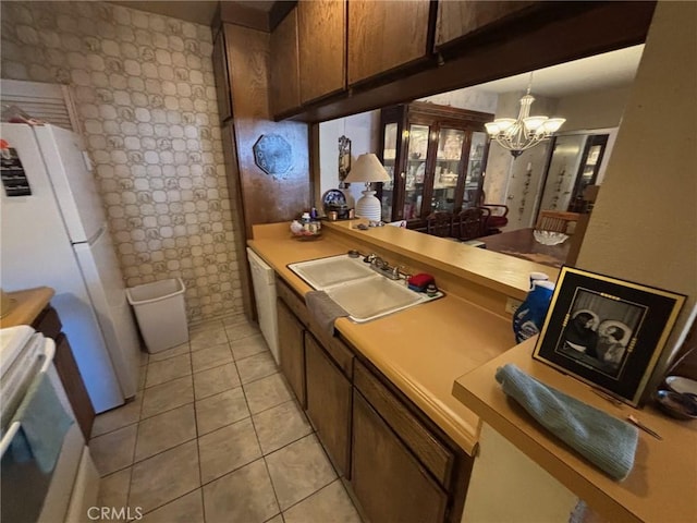 550 W Regent St Unit 338, Inglewood, CA 90301 - kitchen featuring a chandelier, white appliances, light countertops, light tile patterned floors, and hanging light fixtures