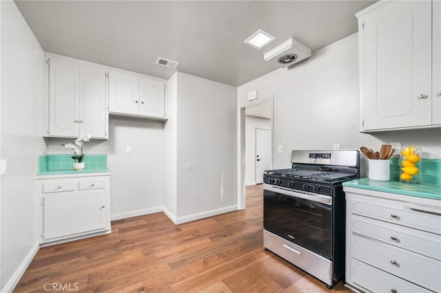 817 W Hollyvale St, Glendora, CA 91740 - kitchen featuring gas range, white cabinets, light wood-type flooring, and tile countertops