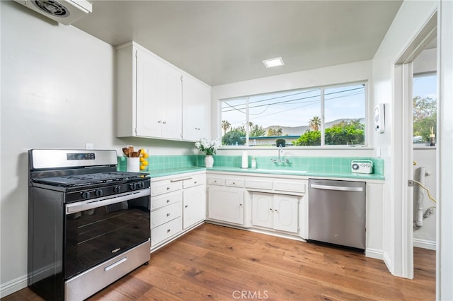 817 W Hollyvale St, Glendora, CA 91740 - kitchen with appliances with stainless steel finishes, light countertops, white cabinetry, light wood finished floors, and plenty of natural light