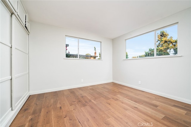 817 W Hollyvale St, Glendora, CA 91740 - unfurnished bedroom featuring multiple windows and light wood finished floors