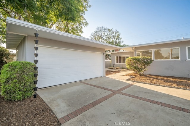 817 W Hollyvale St, Glendora, CA 91740 - view of front of home featuring driveway, an attached garage, and stucco siding