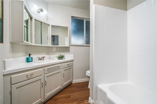 817 W Hollyvale St, Glendora, CA 91740 - bathroom featuring vanity, wood finished floors, and washtub / shower combination