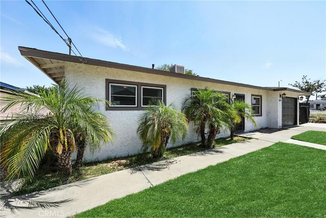 16874 Athol St, Fontana, CA 92335 - view of front of home featuring stucco siding, an attached garage, and a front lawn
