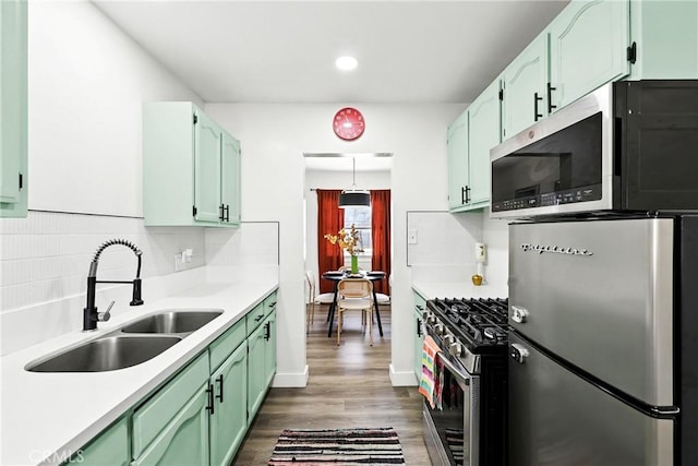 16874 Athol St, Fontana, CA 92335 - kitchen with appliances with stainless steel finishes, tasteful backsplash, light countertops, dark wood-style flooring, and recessed lighting