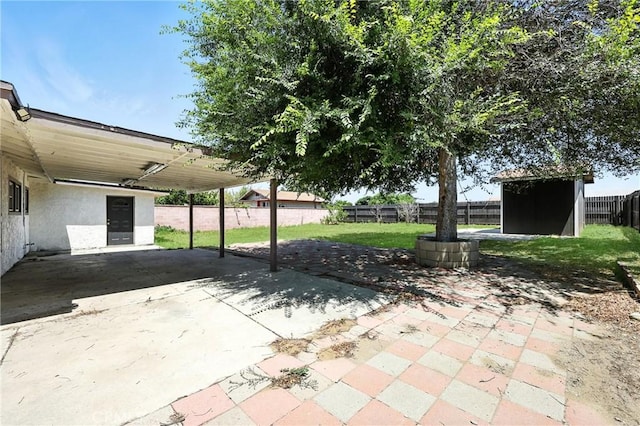 16874 Athol St, Fontana, CA 92335 - fenced backyard with a shed, a patio area, and an attached carport