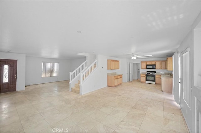 15372 Brandon Ln, Fontana, CA 92337 - unfurnished living room featuring stairs and ceiling fan