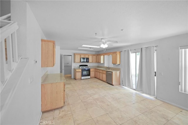 15372 Brandon Ln, Fontana, CA 92337 - kitchen featuring white range with gas stovetop, black microwave, stainless steel dishwasher, light countertops, and light brown cabinets