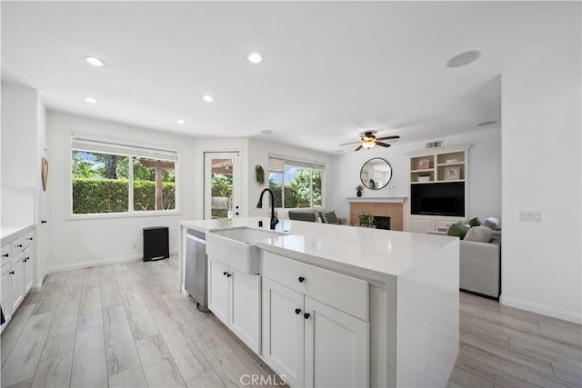 21 Dawnwood, Ladera Ranch, CA 92694 - kitchen with dishwasher, ceiling fan, a fireplace, white cabinets, and recessed lighting