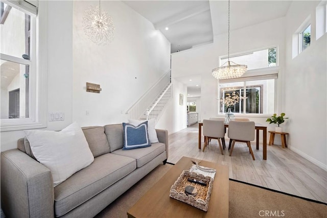 21 Dawnwood, Ladera Ranch, CA 92694 - living room featuring a chandelier, a high ceiling, stairs, light wood-type flooring, and recessed lighting
