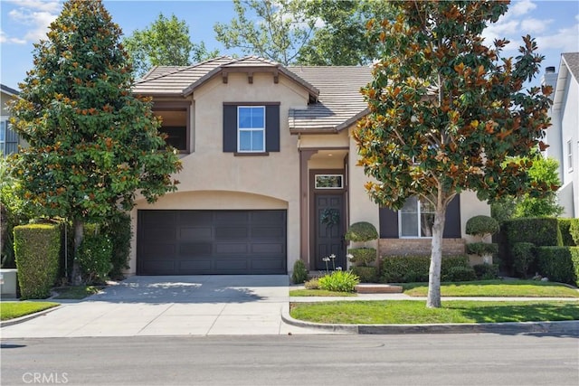 21 Dawnwood, Ladera Ranch, CA 92694 - traditional-style house featuring stucco siding, concrete driveway, a tile roof, and an attached garage