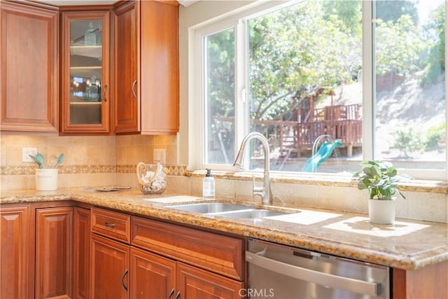 24046 Lindley St, Mission Viejo, CA 92691 - kitchen featuring stainless steel dishwasher, brown cabinetry, and light stone counters